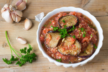 Roasted eggplant pieces with spicy raw tomato dip
