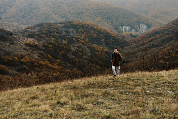 Fototapeta na wymiar Traveler man walking in mountains