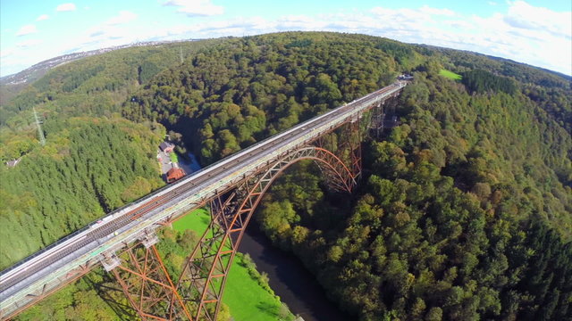 Old bridge constriction over valley river aerial shot Mungstener
