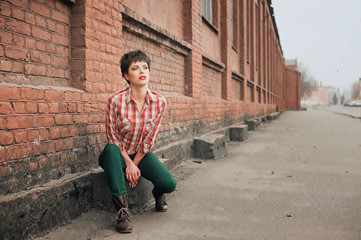 Fototapeta na wymiar Woman wearing checkered shirt and jeans. Short hair