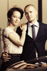 Happy young fashion couple in love at the car