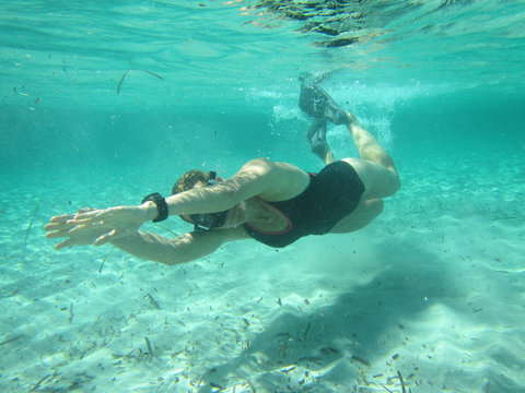 Female Swimmer Diving Underwater