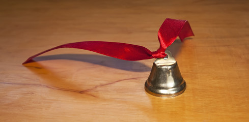 Bell with red ribbon