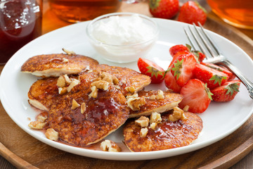 Breakfast with pancakes, fresh strawberries and cream, close-up