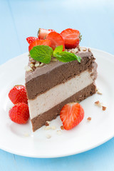 piece of chocolate cake of three layers on plate, vertical