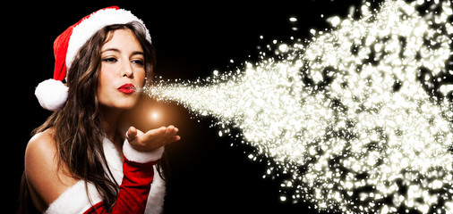 Christmas girl blowing shining snow flakes