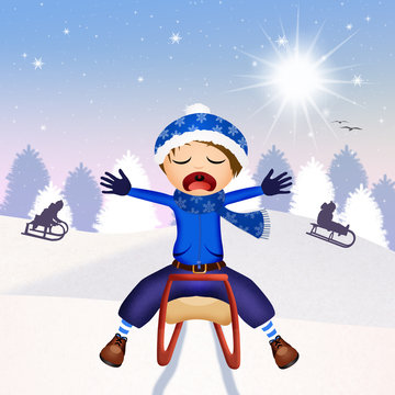 child on sleigh in winter