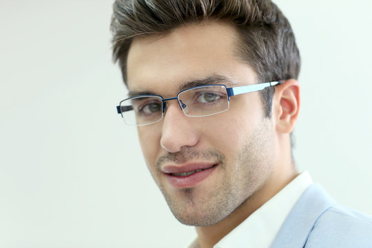 Portrait of young man wearing eyeglasses, isolated
