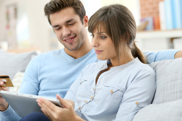 Young couple shopping on internet with tablet