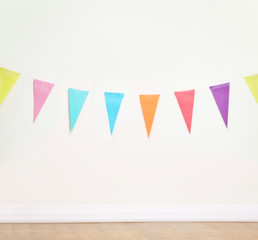Birthday decoration flags on a plain white wall