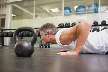 Fit man using kettlebells in his workout