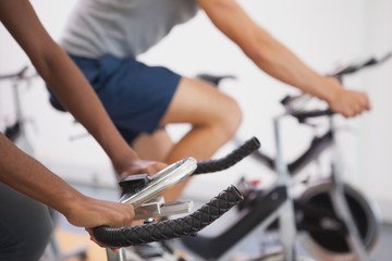 Fit people working out on the exercise bikes