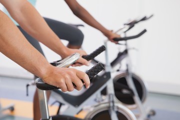 Fit people working out on the exercise bikes