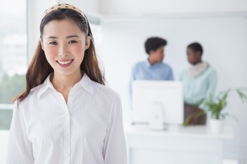 Fototapeta premium Casual businesswoman smiling at camera