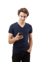 Happy young man writing message on mobile phone