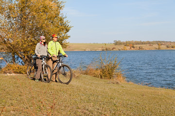 Happy  mountain bike couple cycling outdoors a country walk near