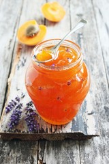 Homemade delicious apricot jam on rustic wooden table