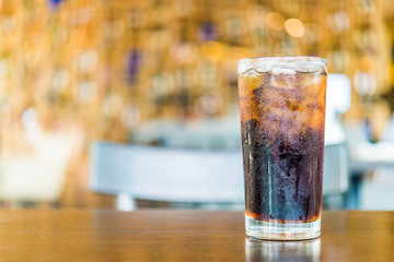 Cola glass on bokeh background