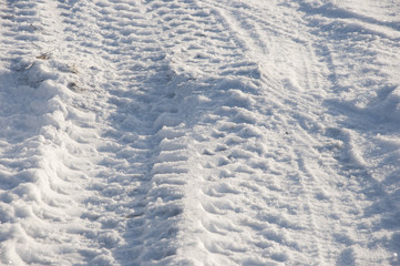 Fototapeta na wymiar Car tires prints on the first snow