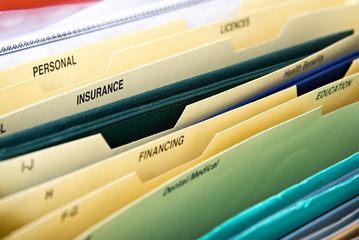 Close up of domestic personal files in expanding pocket folders organizer, labels insurance,...