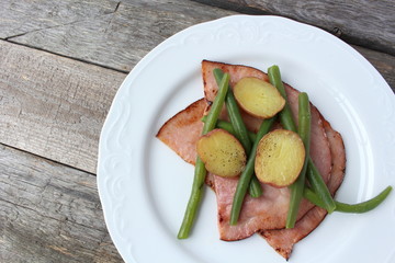 Plate of ham, green beans and creamer potato