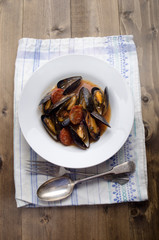 mussel with tomato chorizo sauce on a plate