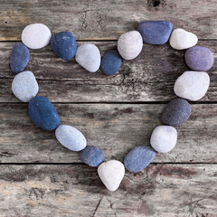 Stone heart on a wooden background