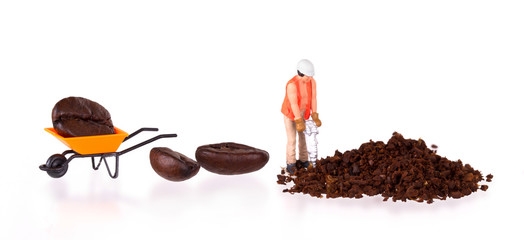 Miniature worker working on a coffee bean