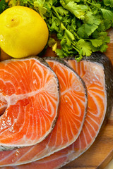 Delicious  portion of fresh salmon fillet with lemon and parsley