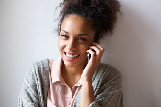 Young woman smiling and talking on mobile phone