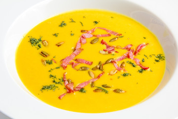 Closeup yellow pumpkin soup with seeds