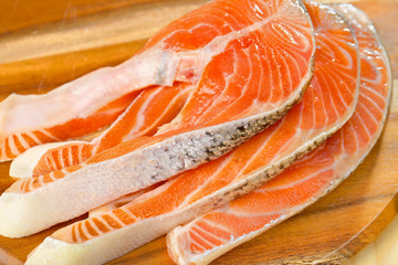 Delicious  portion of fresh salmon fillet on a wooden table