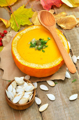Pumpkin soup on rustic table