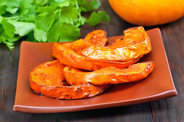 Slices of baked pumpkin with honey