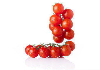 Red tomatoes with drops isolated on white