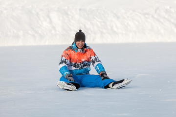 Young boy, one skate on the frozen lake
