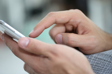 Closeup of hands using smartphone
