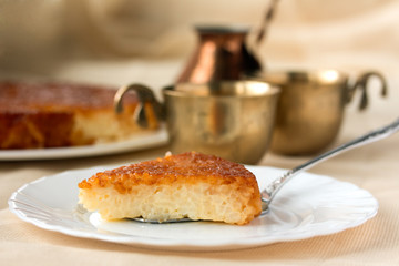 Caramel pudding on wooden table with turkish coffee pot and