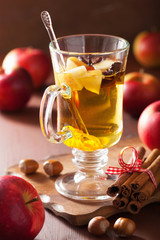 glass of mulled apple cider with orange and spices, winter drink