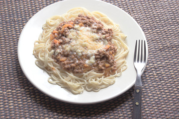Spaghetti bolognese on plate with fork