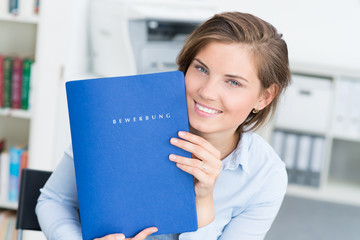 Close up portrait of beautiful woman showing her portfolio