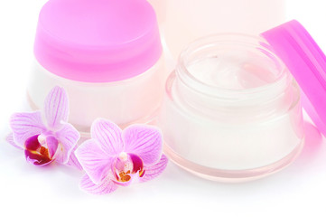 Obraz na płótnie Canvas Face creams and beautiful orchid flowers on white background