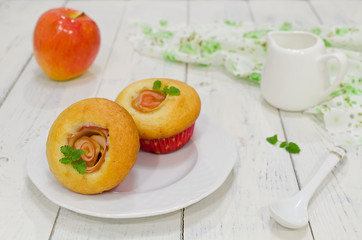 Apple muffins with fresh apples on a wooden background
