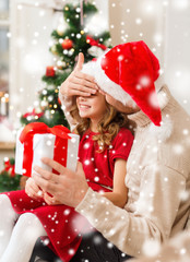 smiling father and daughter holding gift box