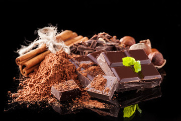 Pile of hazelnut chocolate on black background