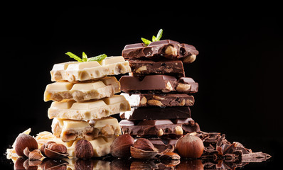 Pile of hazelnut chocolate on black background