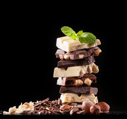 Pile of hazelnut chocolate on black background