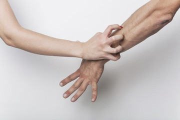 Angry woman scratching man's arm