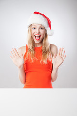 Christmas woman in santa hat holding empty board