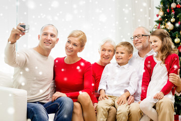 smiling family with camera at home